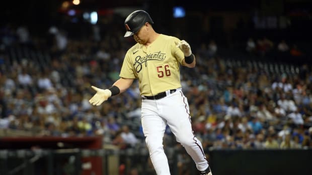 Diamondbacks outfielder Kole Calhoun (56) celebrates after hitting a solo home run for the Diamondbacks.